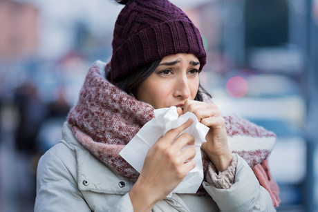 Sick woman outside - how to stay healthy this winter